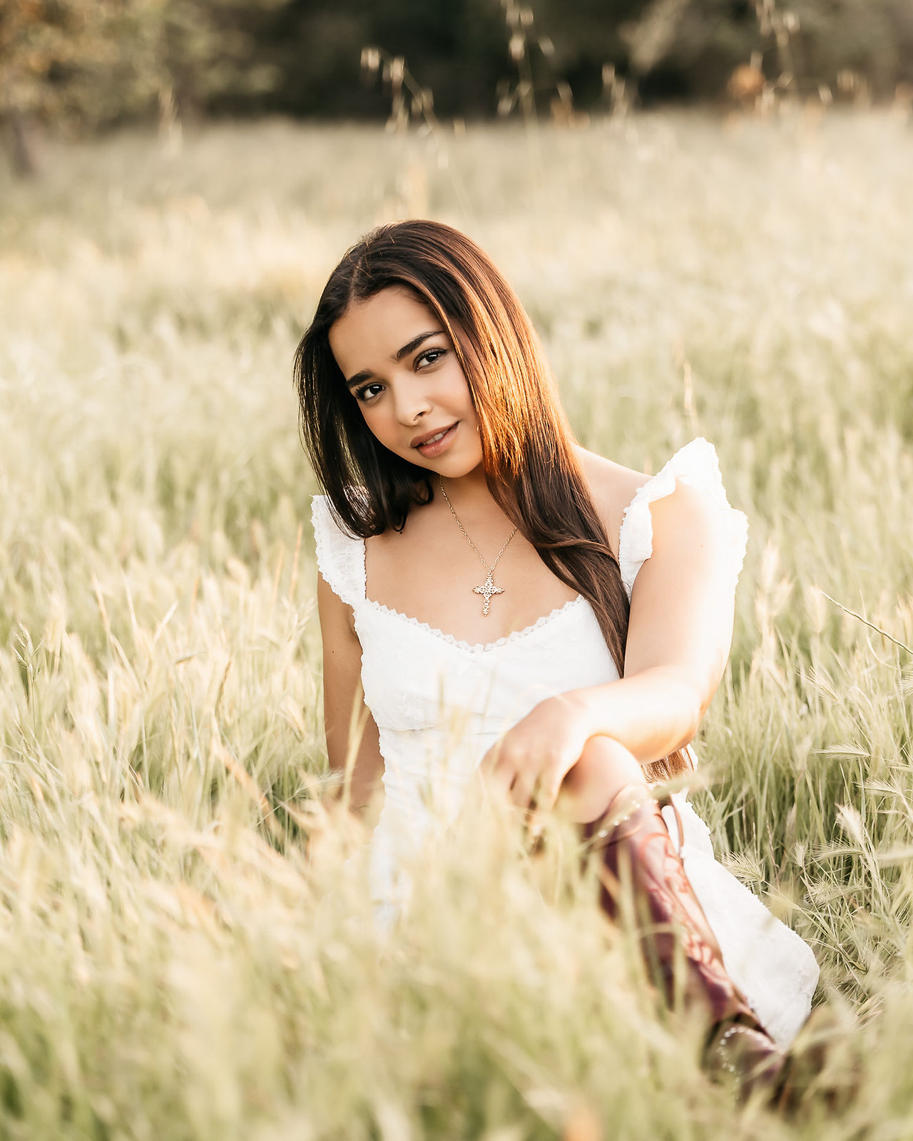 high school senior in a field in a white dress