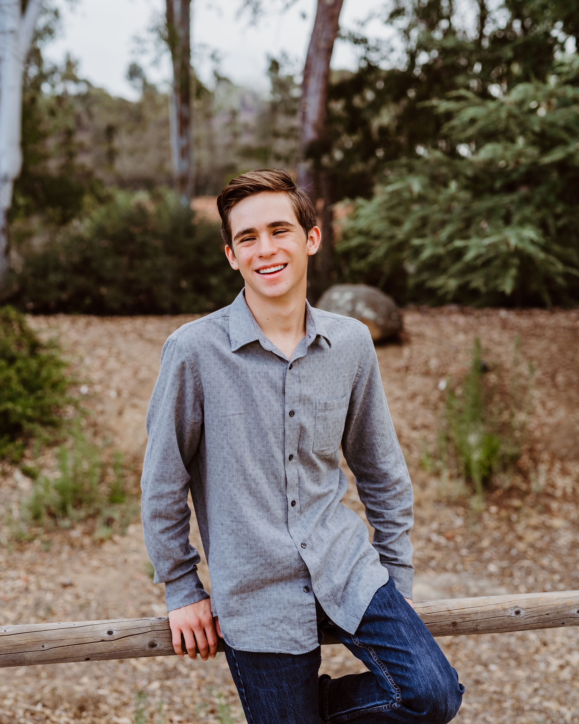 senior photos of a young man in a park in San Diego