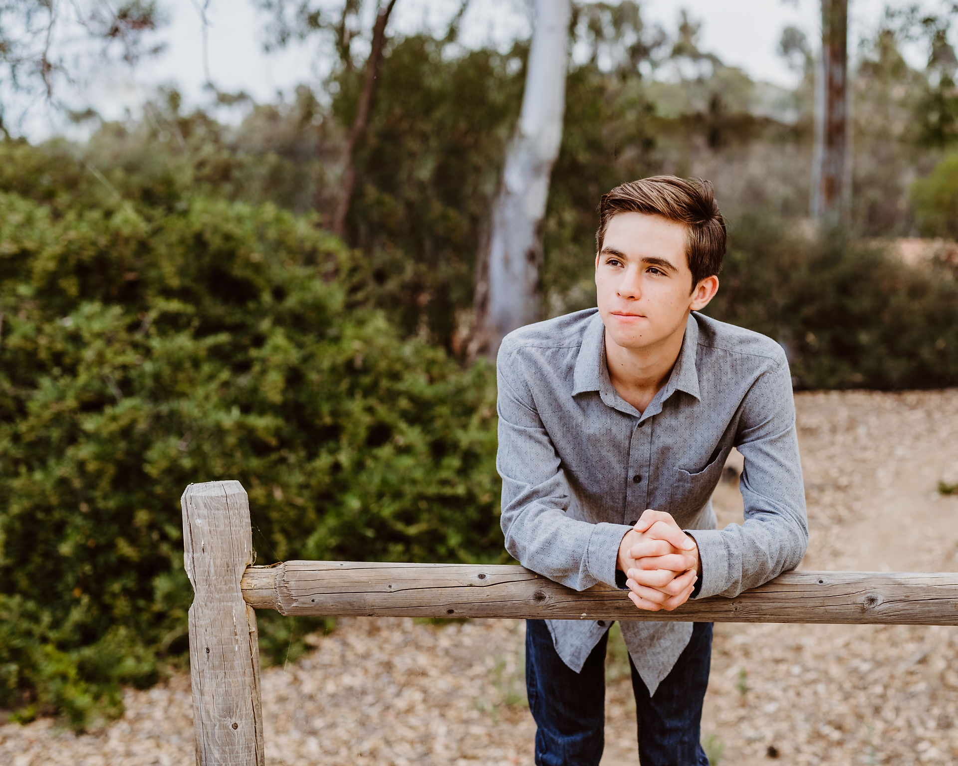 senior photos of a young man in a park