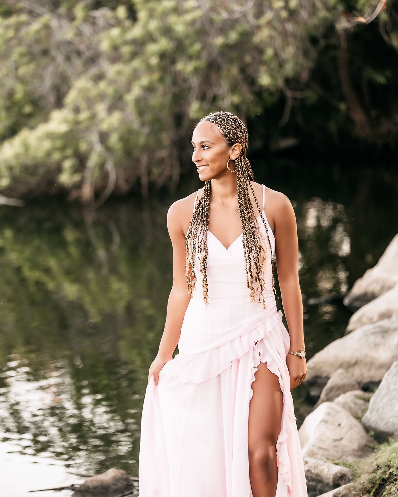 Luxury San Diego senior photography session capturing natural movement and light in a park landscape.
