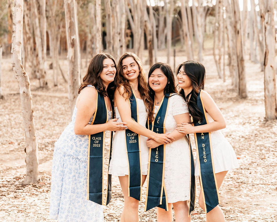 UCSD graduation photos with friends walking through eucalyptus grove on campus wearing Class of 2025 stoles