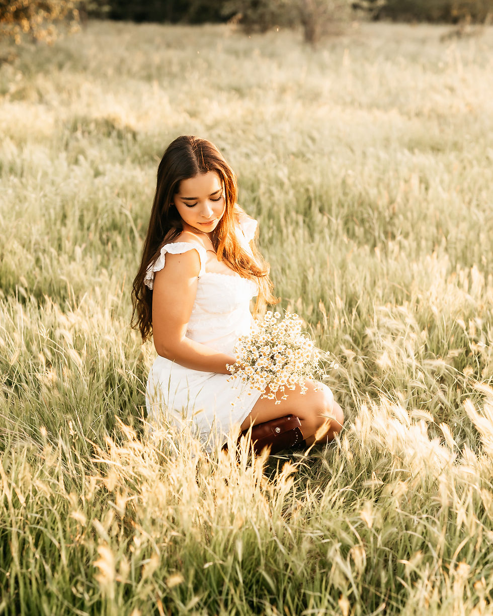 high school senior photos in a grassy field.
