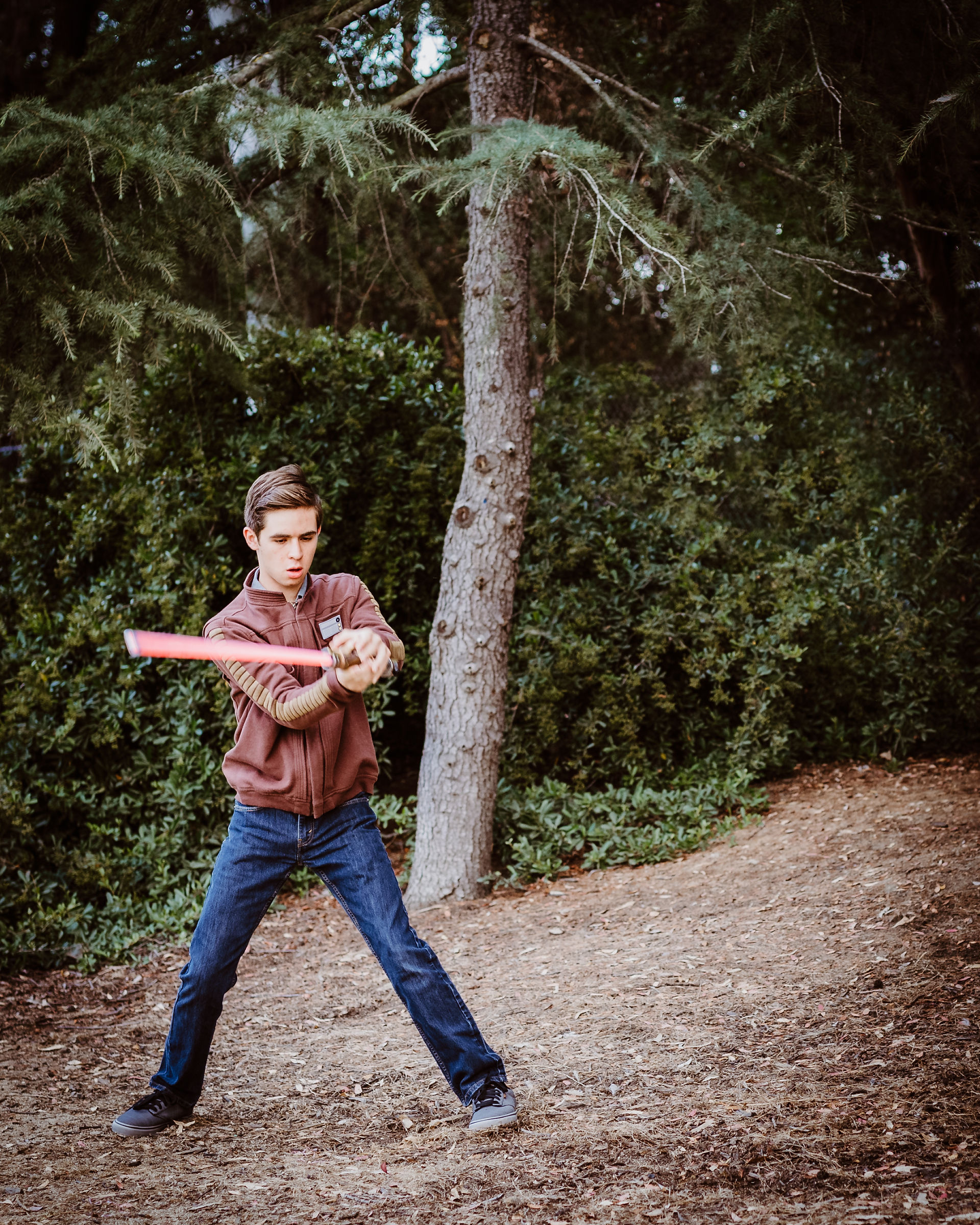 senior photos of a young man in a park
