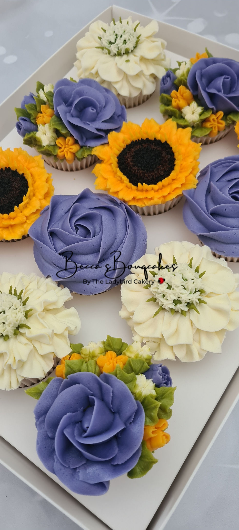 Buttercream flower cupcakes in yellow, blue and cream
