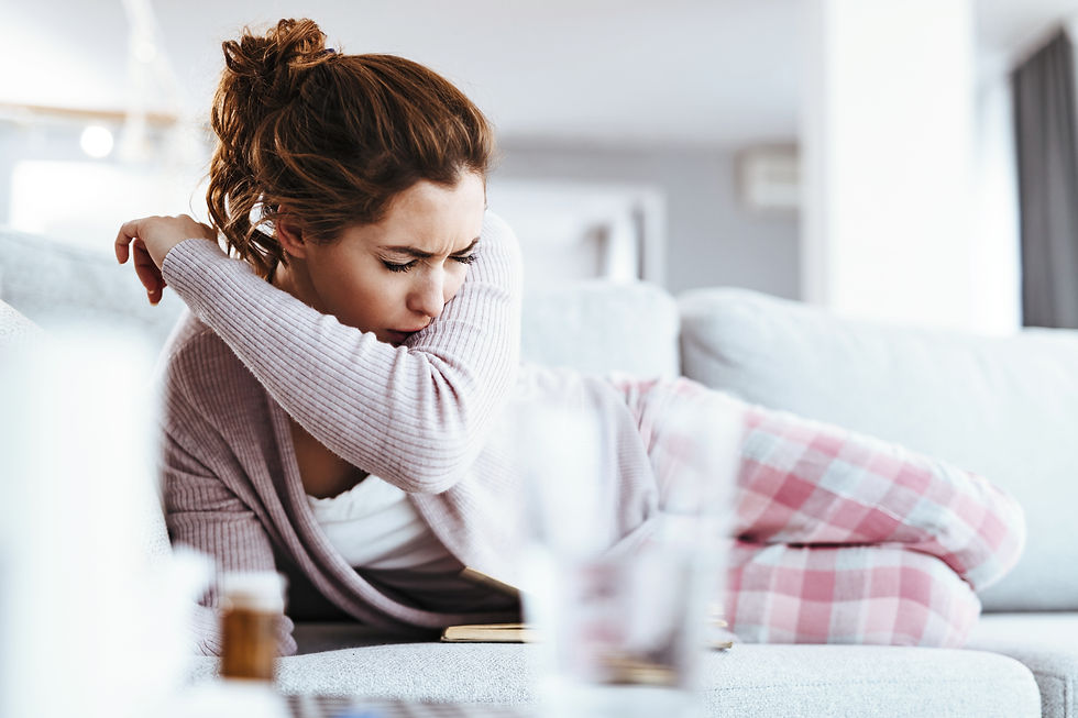 This image shows a woman lying on the cough sick and coughing. She has a respiratory illness or asthma or GERD.