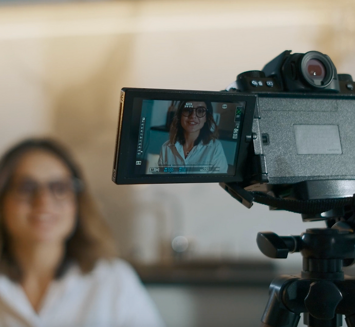 young woman speaking in front of a camera