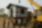 a crane loading a recycled plastic house on to a truck