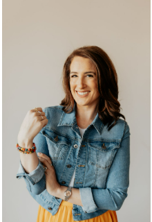 Professional headshot of Sarah Pence, CEO and Founder of Pence Creative, wearing a casual denim jacket and smiling