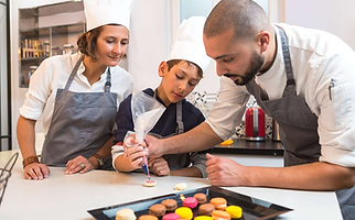 A family making macarons with aprons on