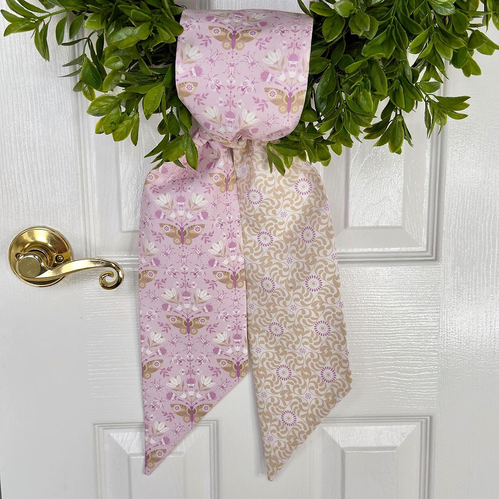 Thumbnail: Lavender butterfly wreath sash tied in a simple knot at the base of a green wreath on a front door.