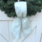Handmade Simple Knot wreath sash in shimmering mineral blue with silver finish, styled on a green Christmas wreath