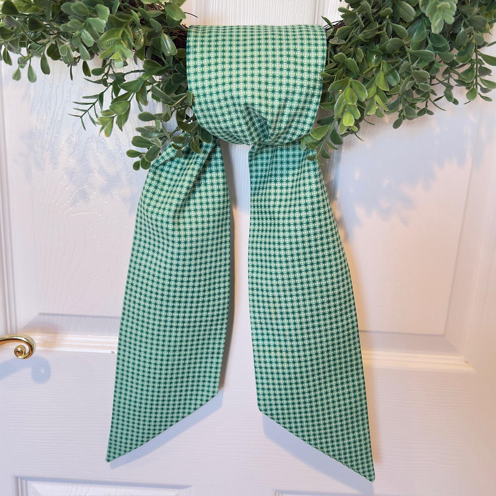 Thumbnail: Green Celtic cross wreath sash draped over a boxwood wreath on a front door, featuring embroidered Celtic cross detail.