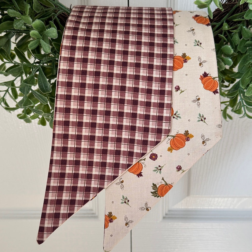 Thumbnail: close up of each tail of the burgundy and pumpkin wreath bow sash