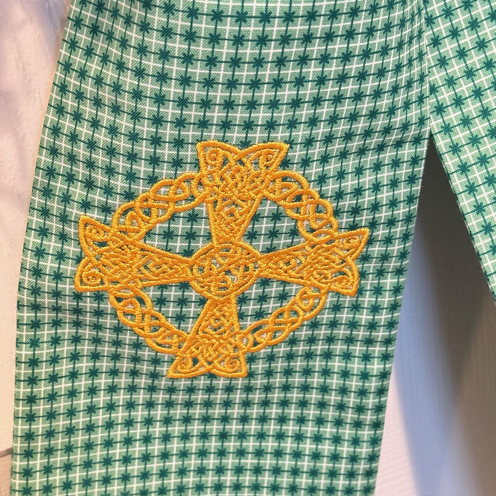 Thumbnail: Green Celtic cross wreath sash draped over a boxwood wreath on a front door, featuring embroidered Celtic cross detail.