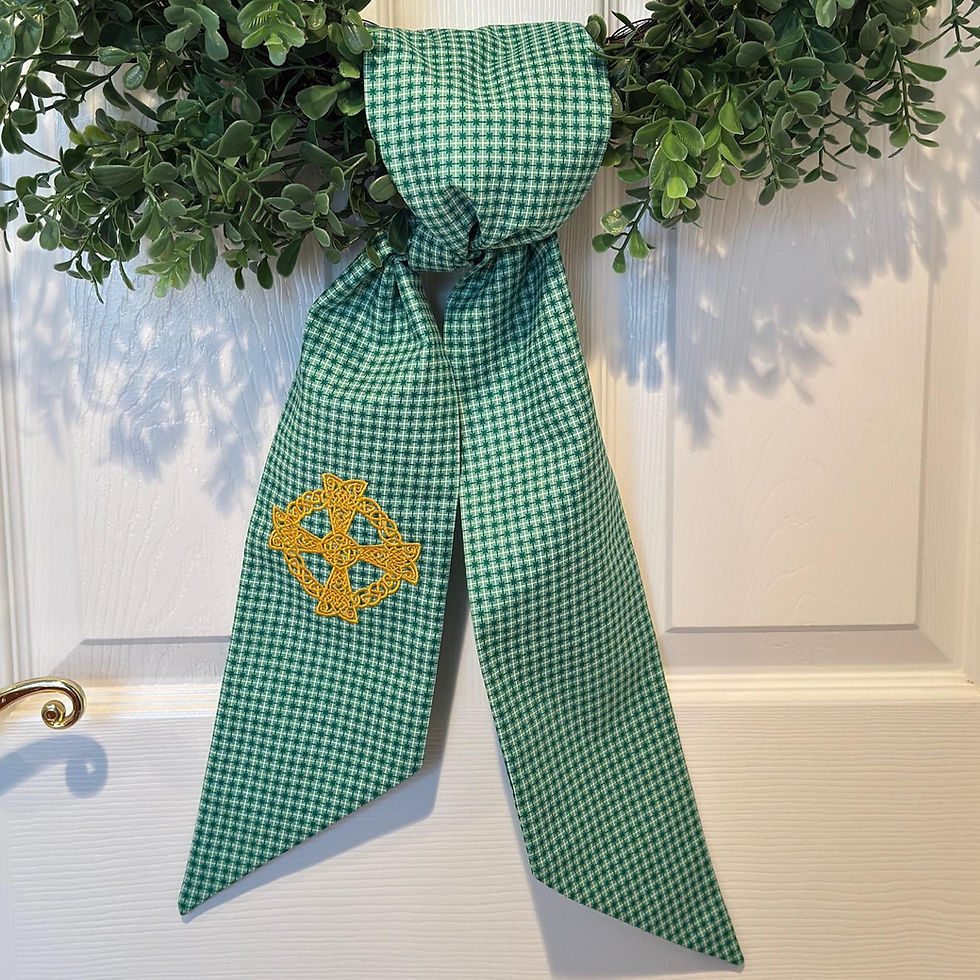 Thumbnail: Green Celtic cross wreath sash draped over a boxwood wreath on a front door, featuring embroidered Celtic cross detail.