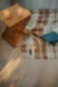Folk Copper blanket displayed beside a book and cup on a cozy indoor rug.