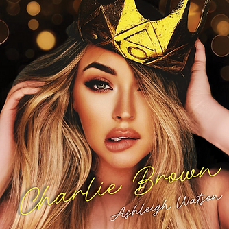 Image of Ashleigh Watson on new single 'Charlie Brown' cover. Wearing golden crown tilted to the side. Sultry eyes and natural coloured lips with long blonde hair. Looking directly into camera with bewildered lip pout