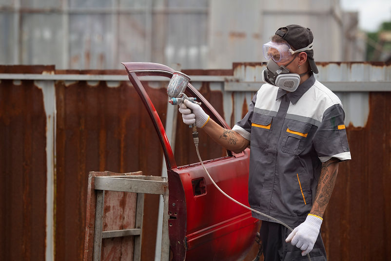side-view-man-spraying-powder-paint-car-door.jpg
