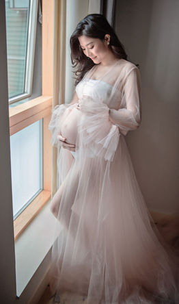maternity photoshoot London Hong Kong mum tulle dress window light elegant pregnancy portrait