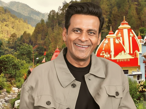 Manoj Bajpayee in a beige jacket stands in front of colorful red and white temple, nestled in lush green mountains with a vibrant, serene backdrop.
