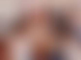 Women and people of different races and religions sitting around a table and participating in a collage and arts workshop