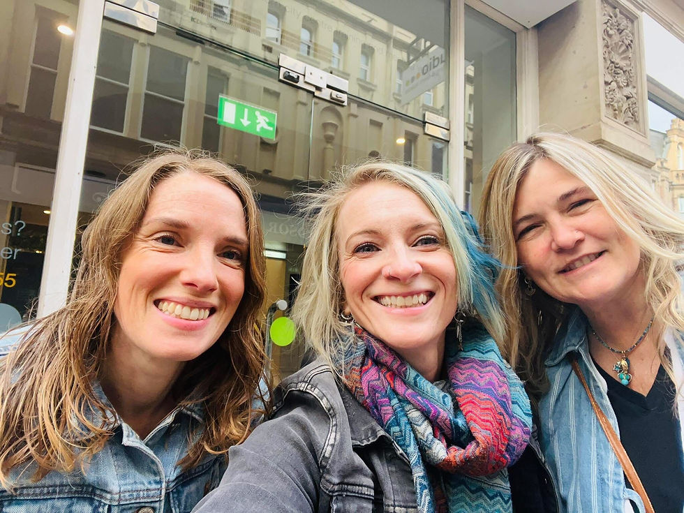 Selfie of Sarah, Abi & Mel outside their conference venue in Birmingham, all smiling at the camera