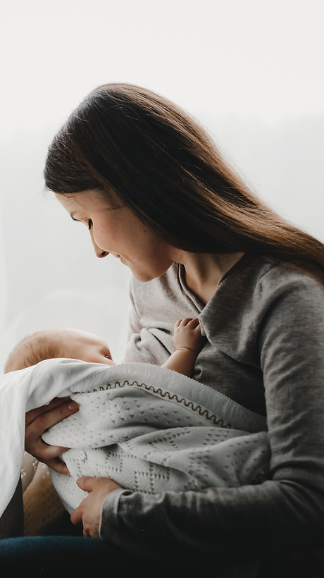 mother-holds-newborn-boy-her-arms-while-