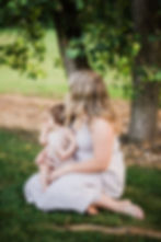 a mom and baby looking at something
