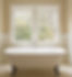 White clawfoot bathtub in front of a window