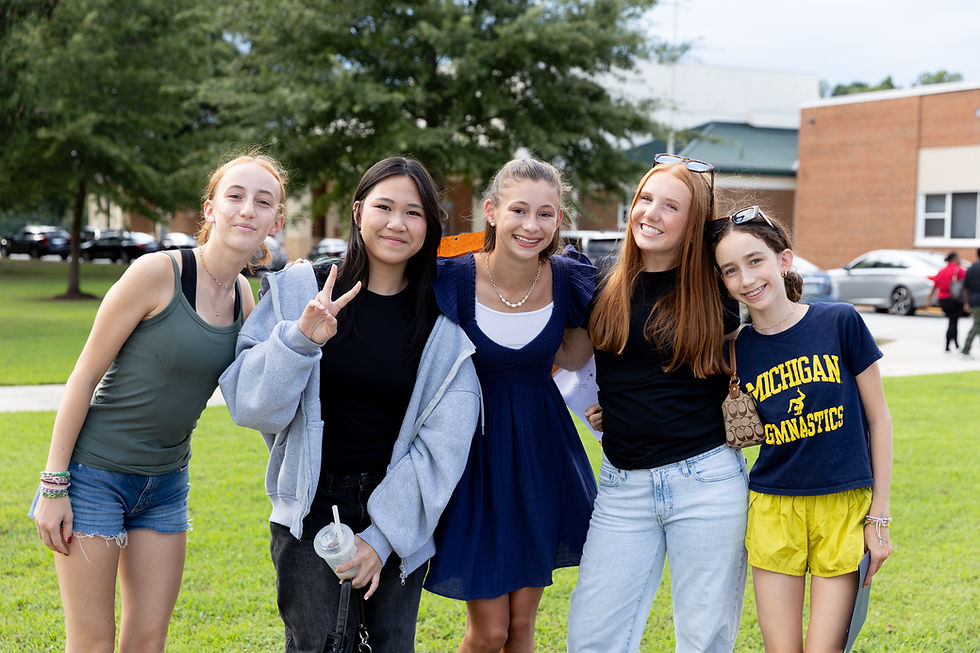 Five Prince Edward County Public Schools students gather on the front lawn of the schools during Welcome Back Night.