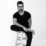 man-cross-legs-seating-on-white-wooden-c