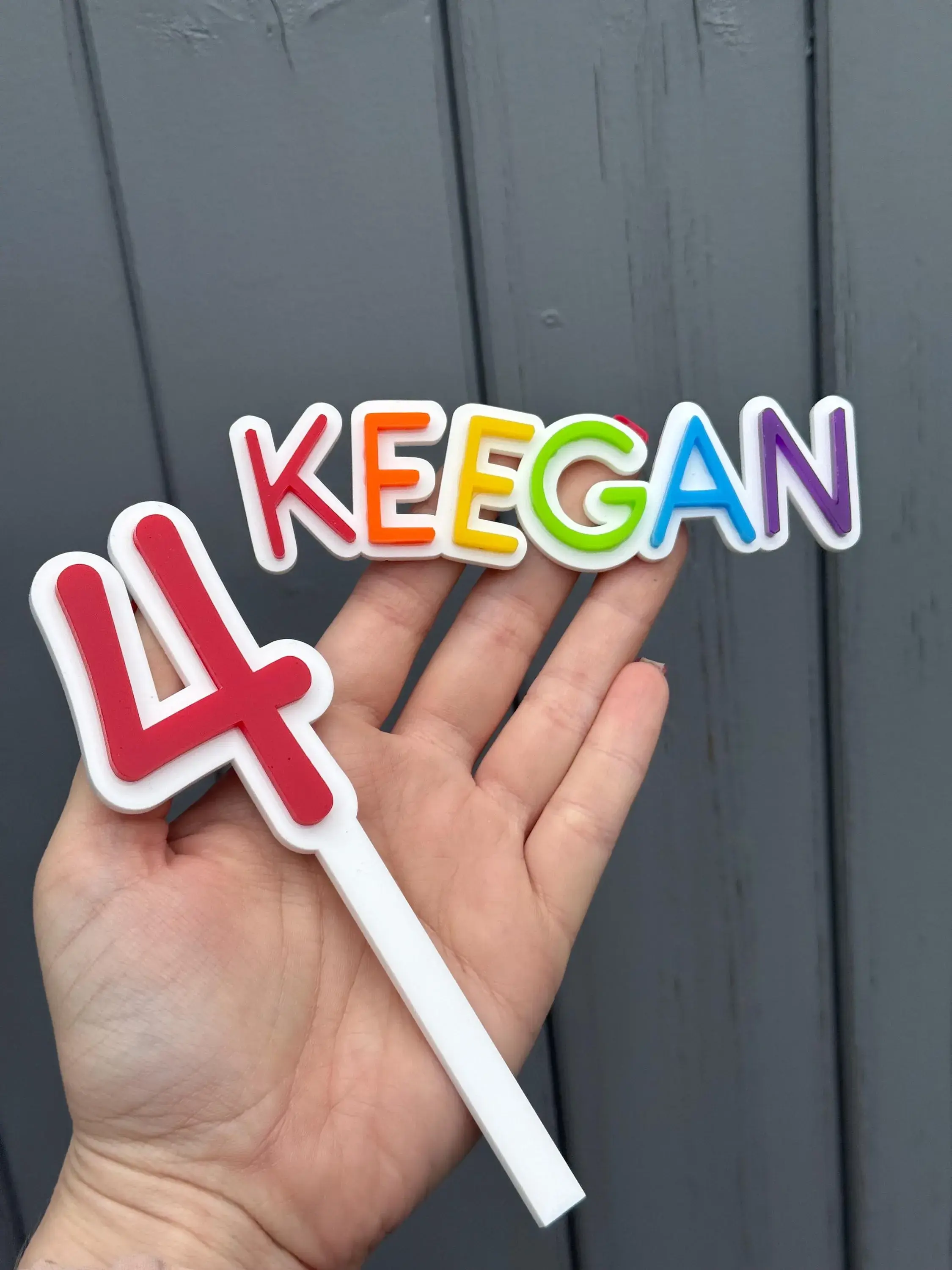 Hand holding KEEGAN name and number 4
