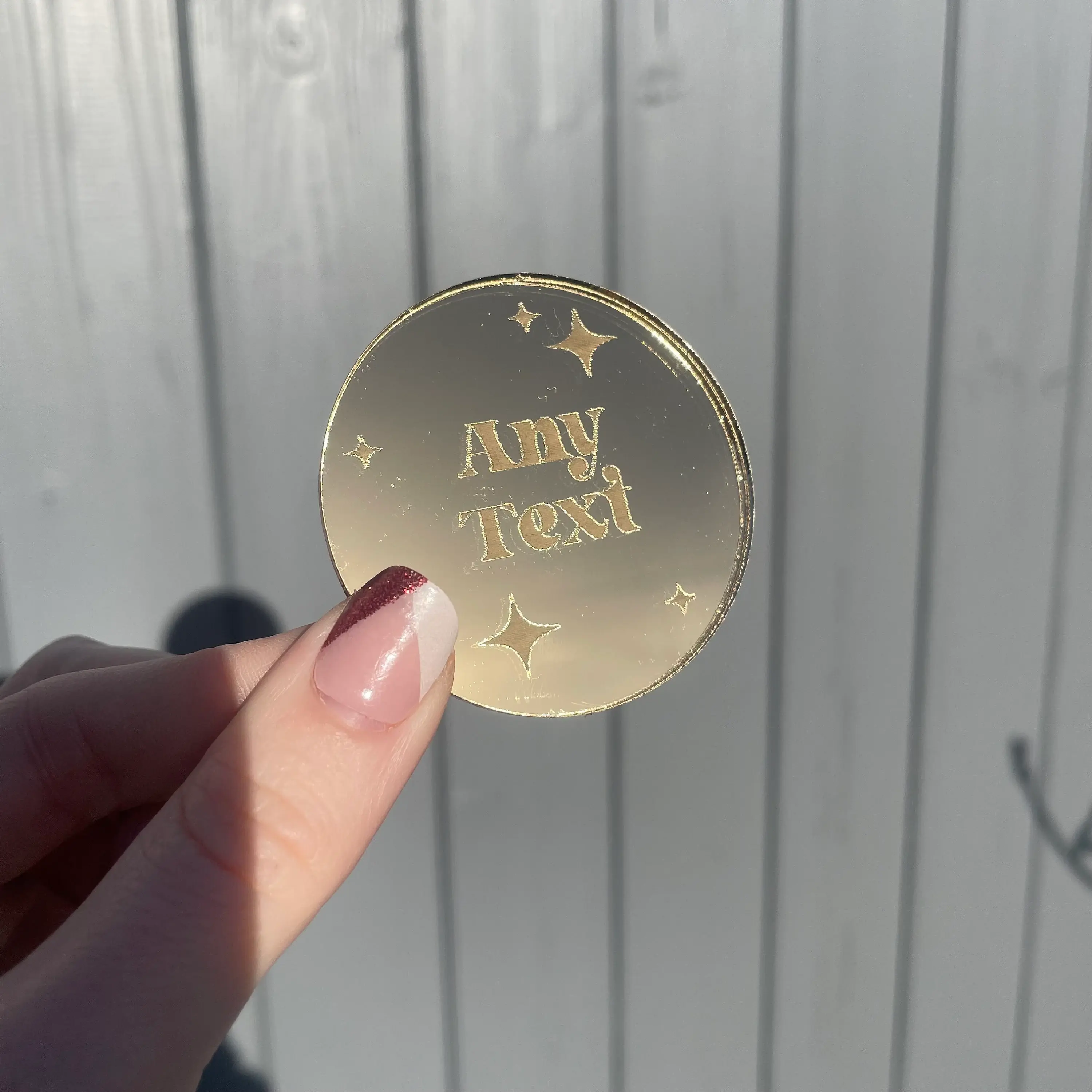 Golden 'Any Next' disc held in hand