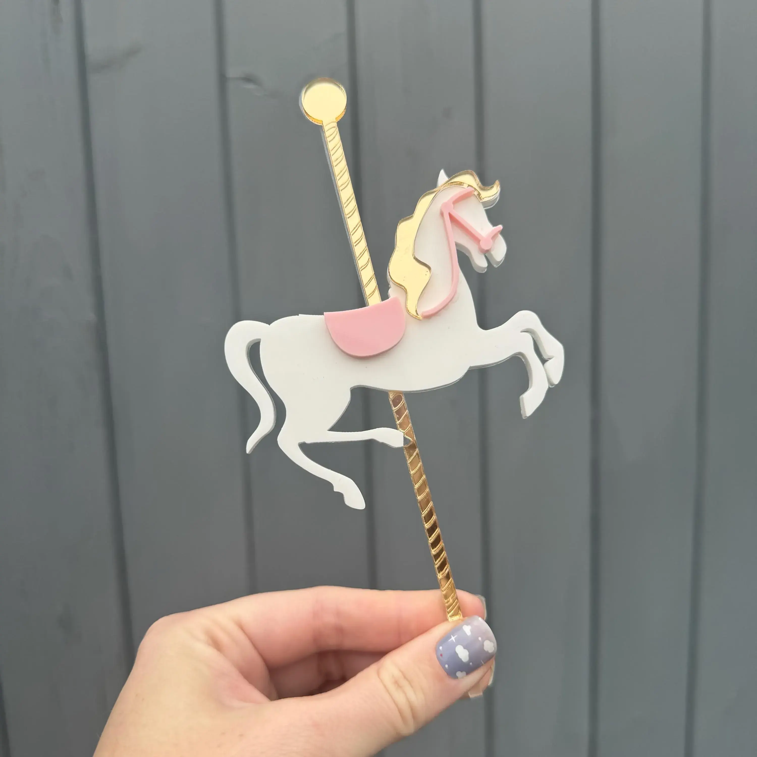 White carousel horse topper with pink and yellow