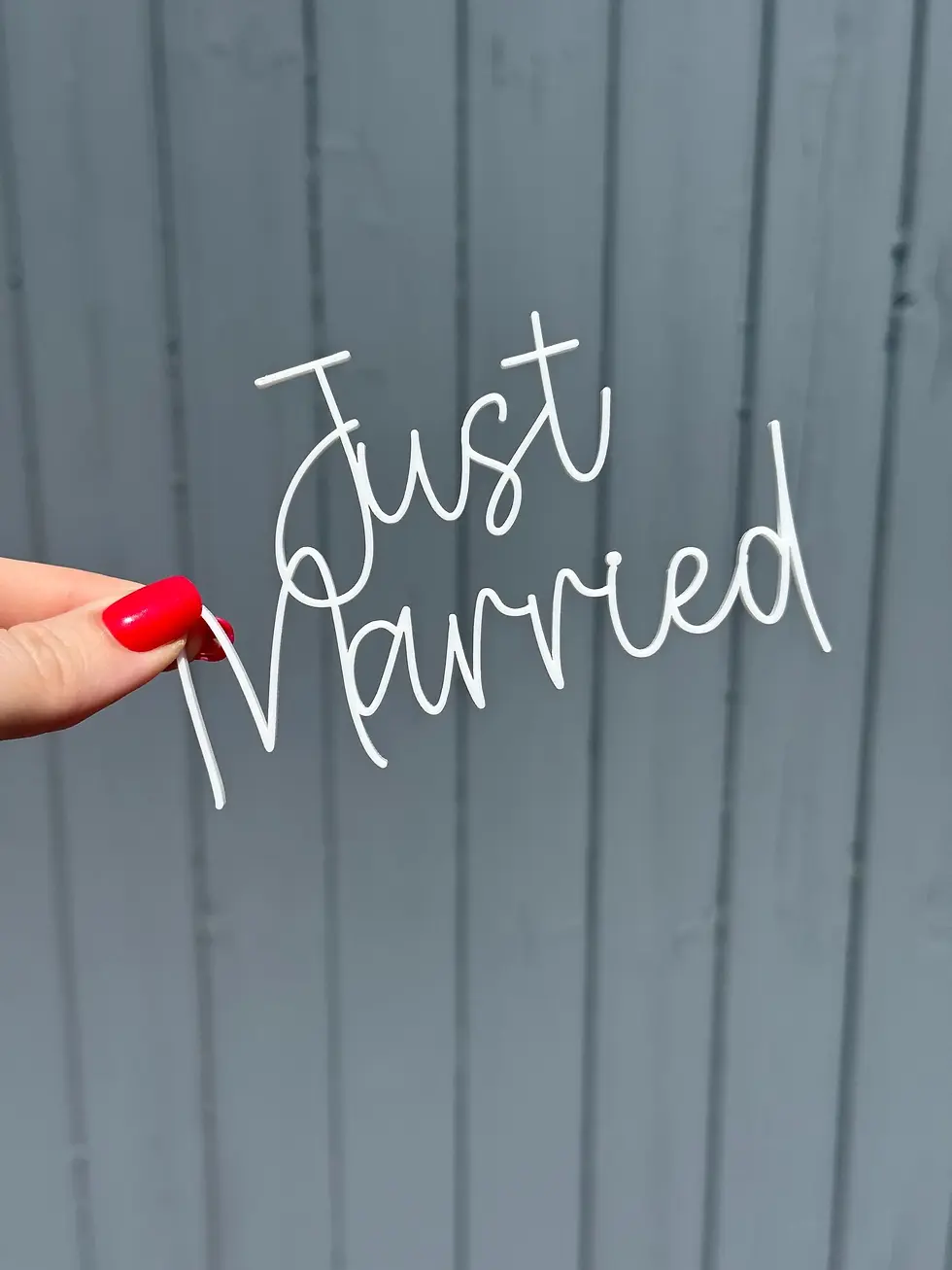 Thumbnail: Hand holding white 'Just Married' sign
