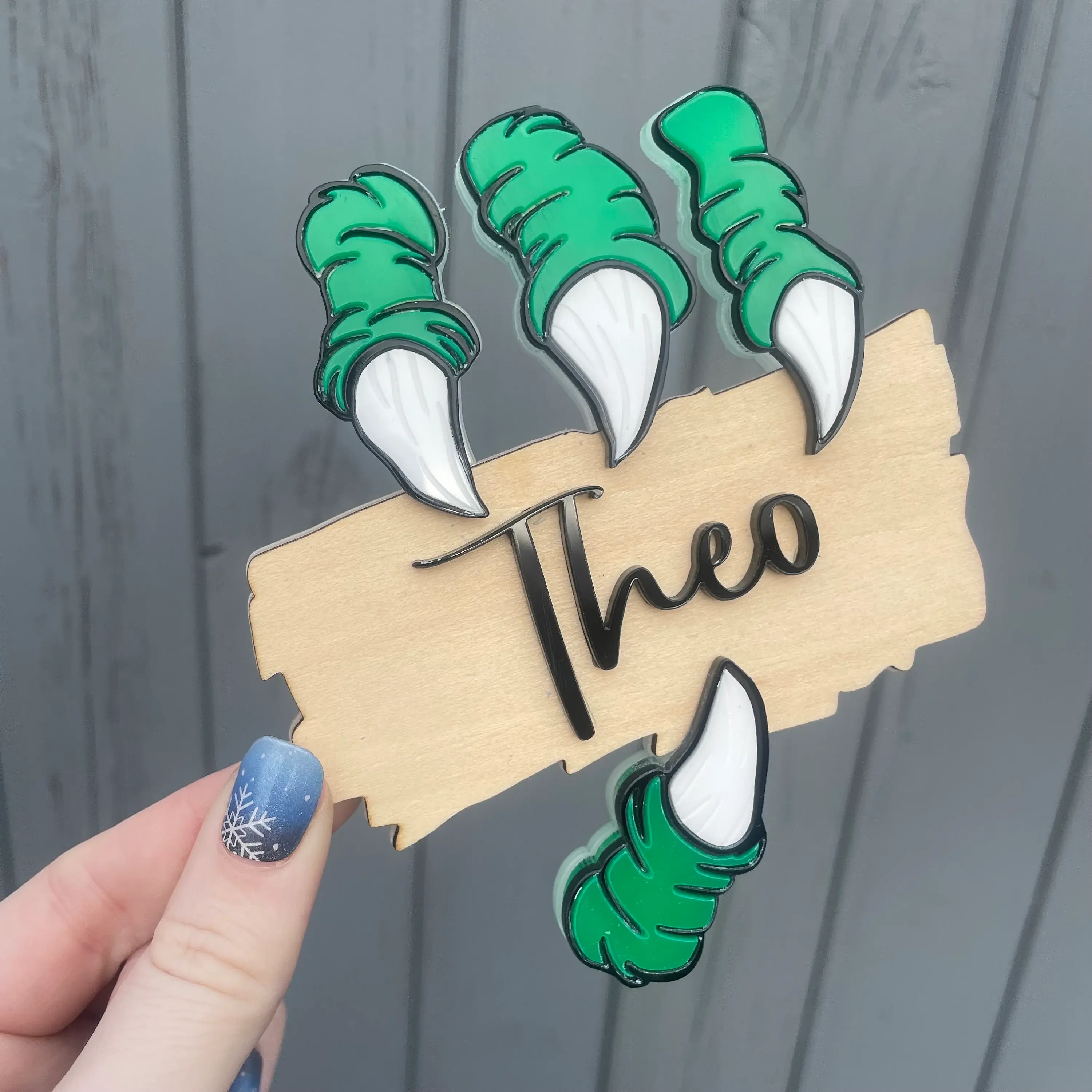 Green monster claw name sign with 'Theo'