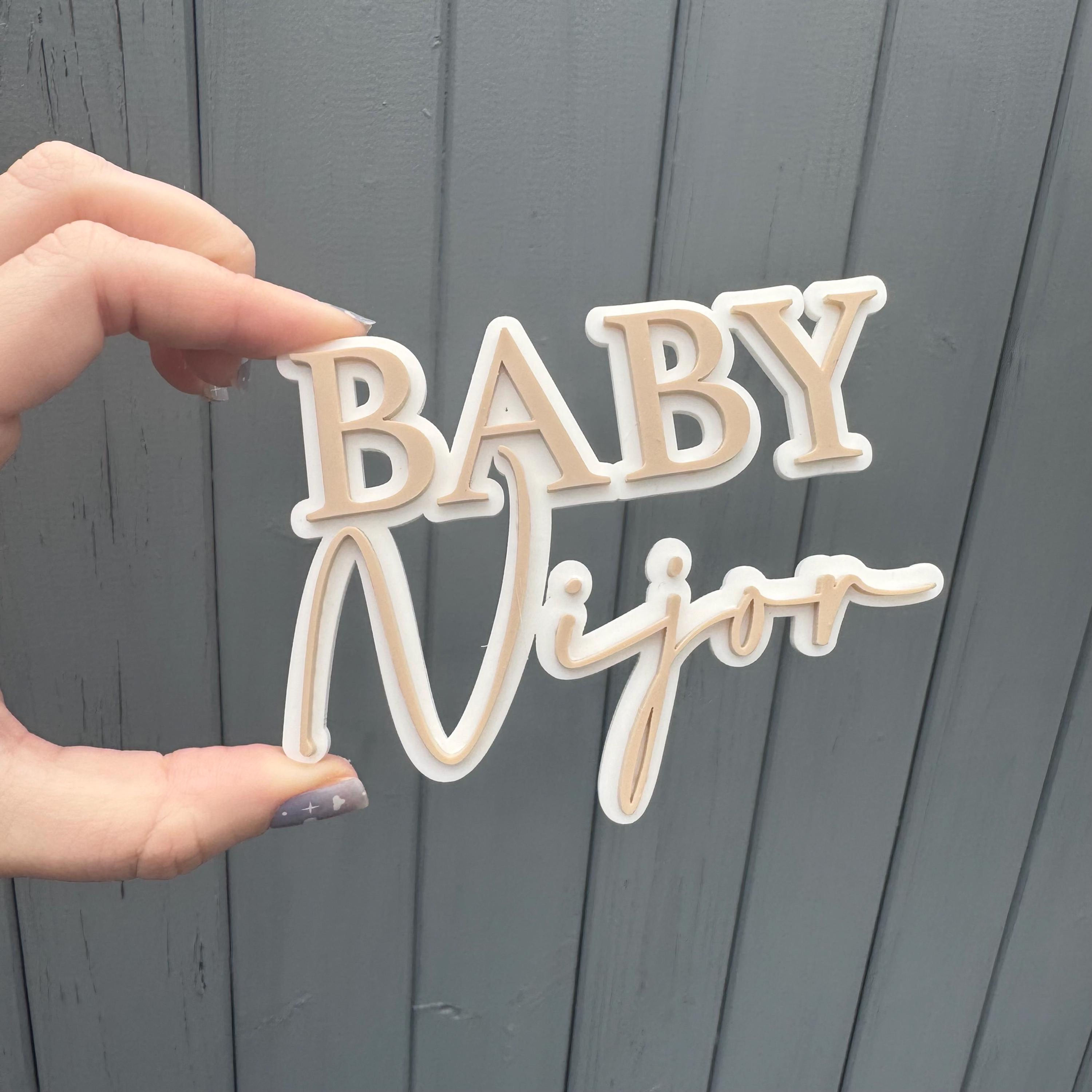BABY Niyaa sign held in hand