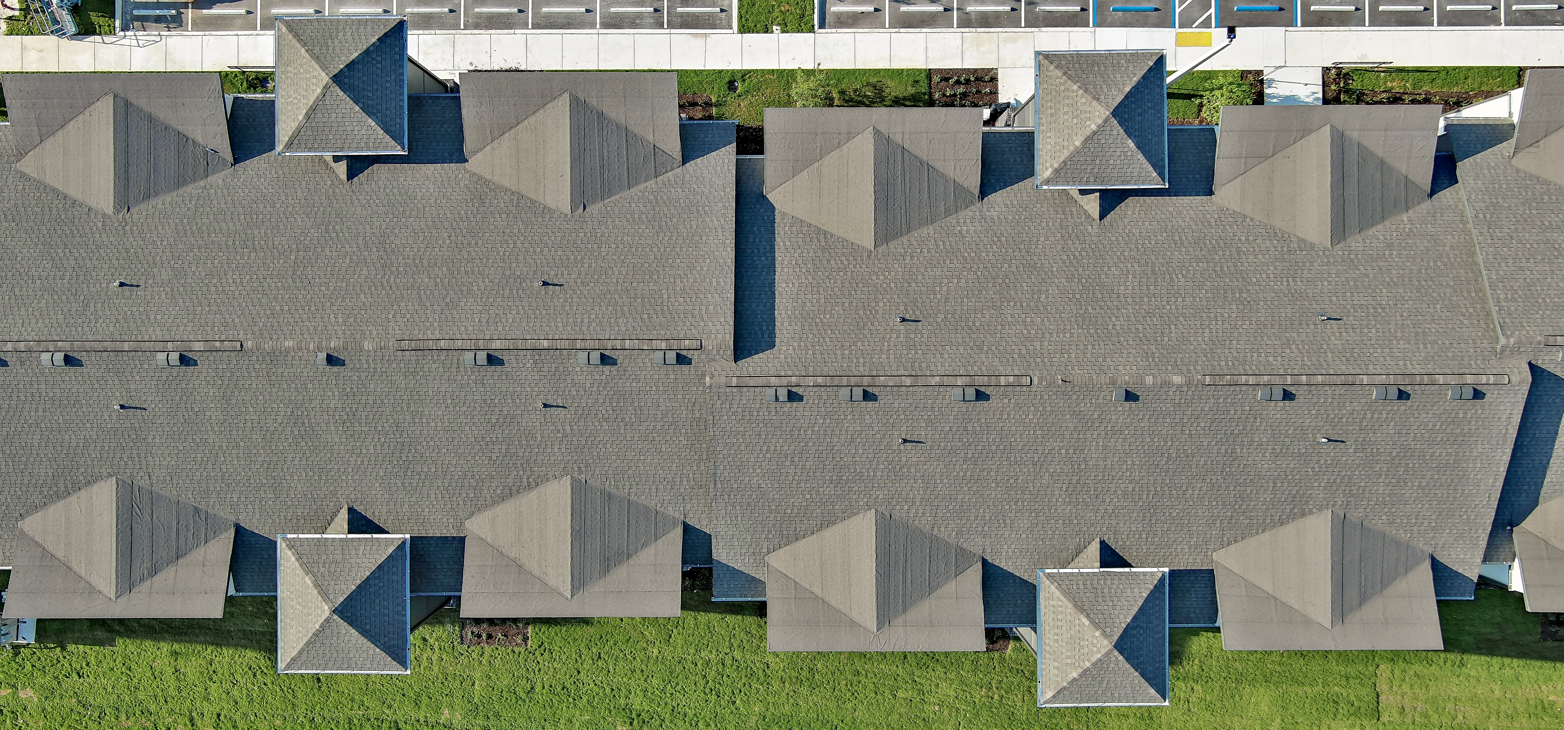 Aerial top-down view of apartment building rooftops from a roof inspection project