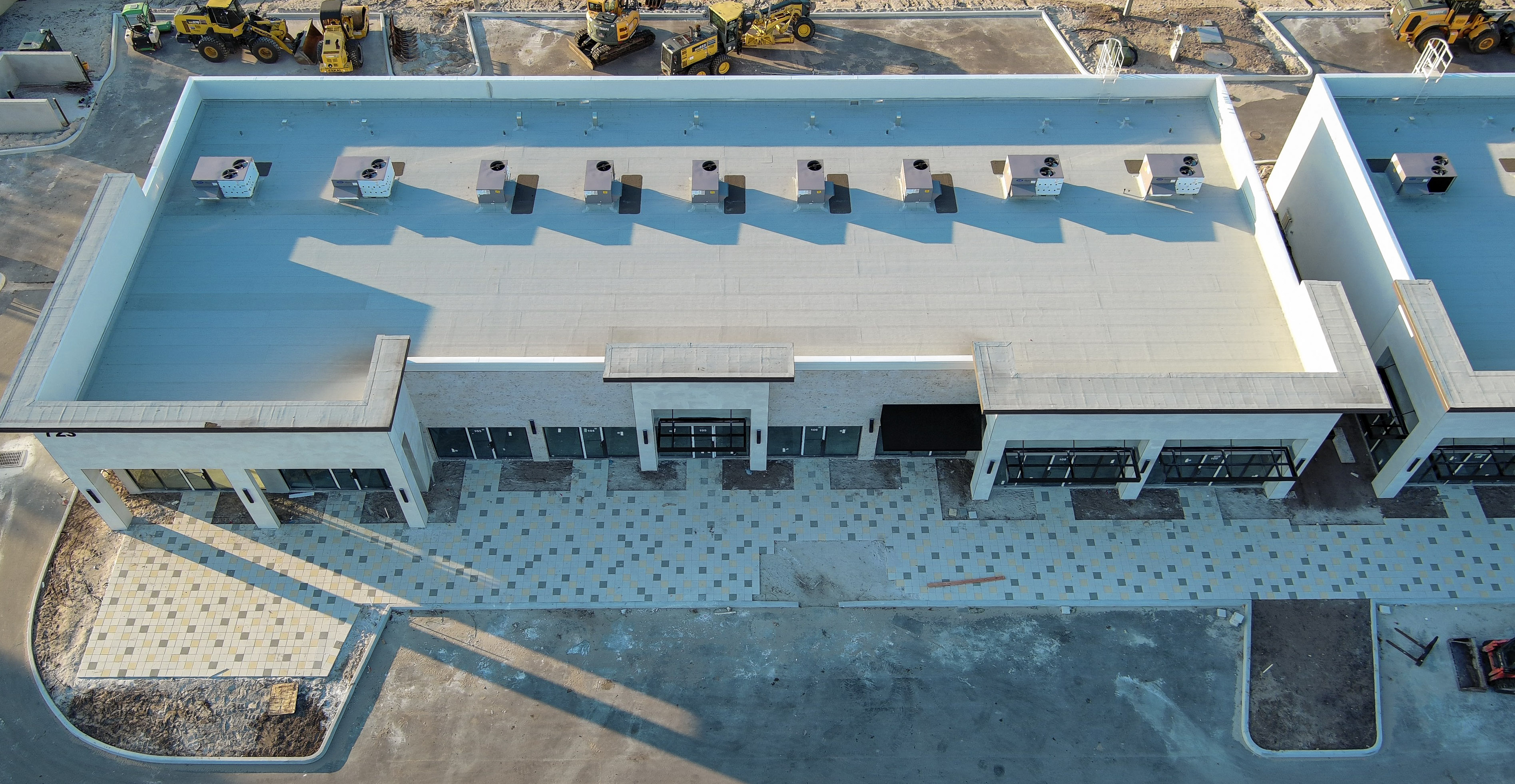 Aerial view of an L-shaped commercial building from a property documentation project