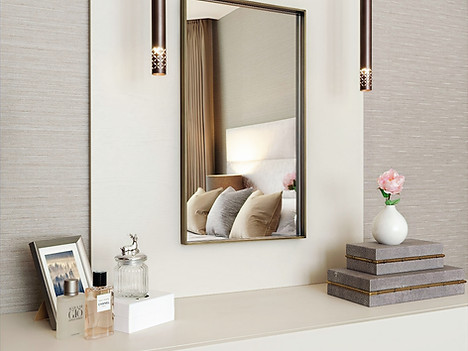 a bedroom with a large mirror