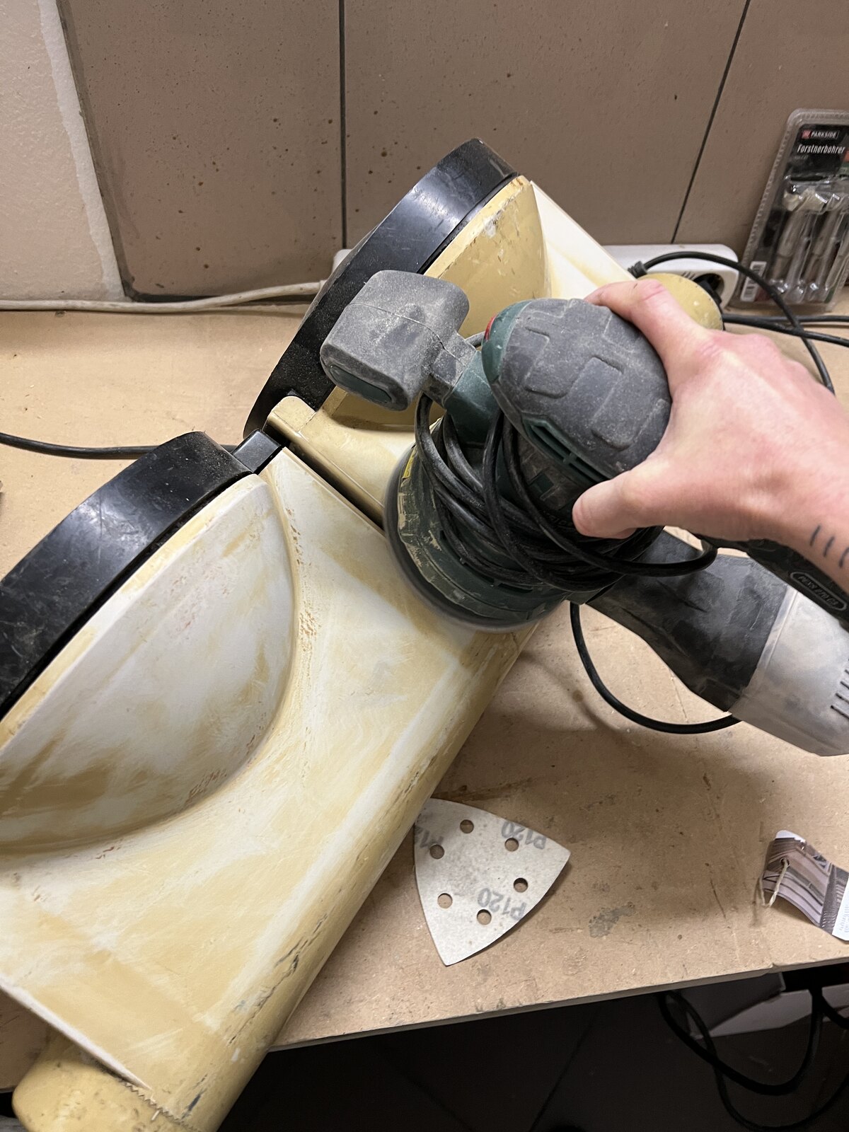 Sanding the housing back to a clean surface.