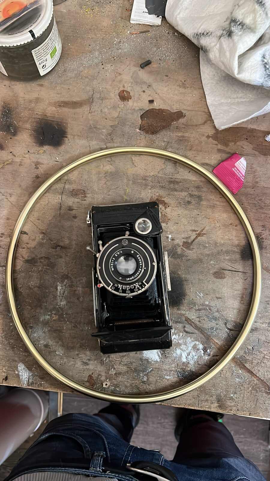 Folding camera inside the brass ring on the bench