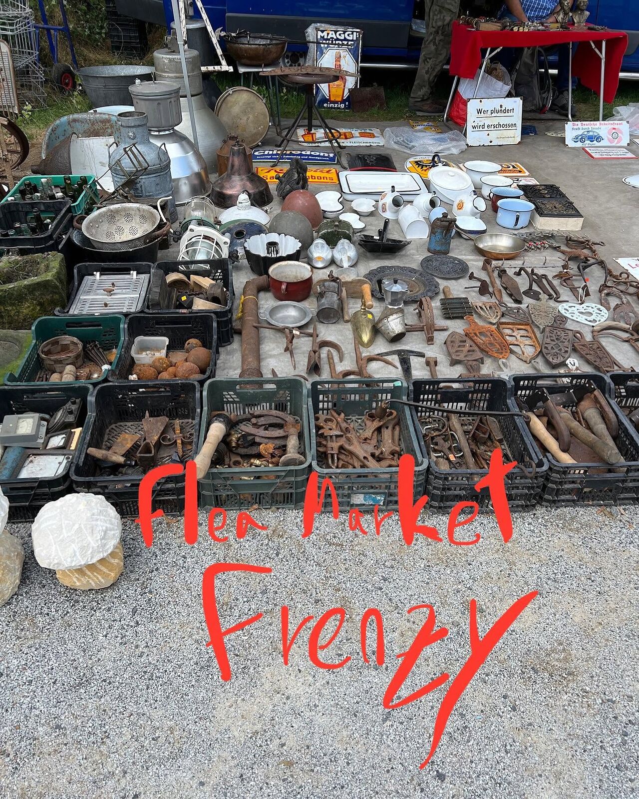 Flea market tables covered in old metal objects, with my caption: Flea Market Frenzy