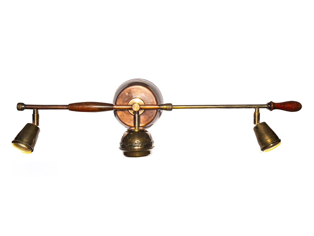 A French pesticide pump with wooden handles, made into a wall light with three brass spots