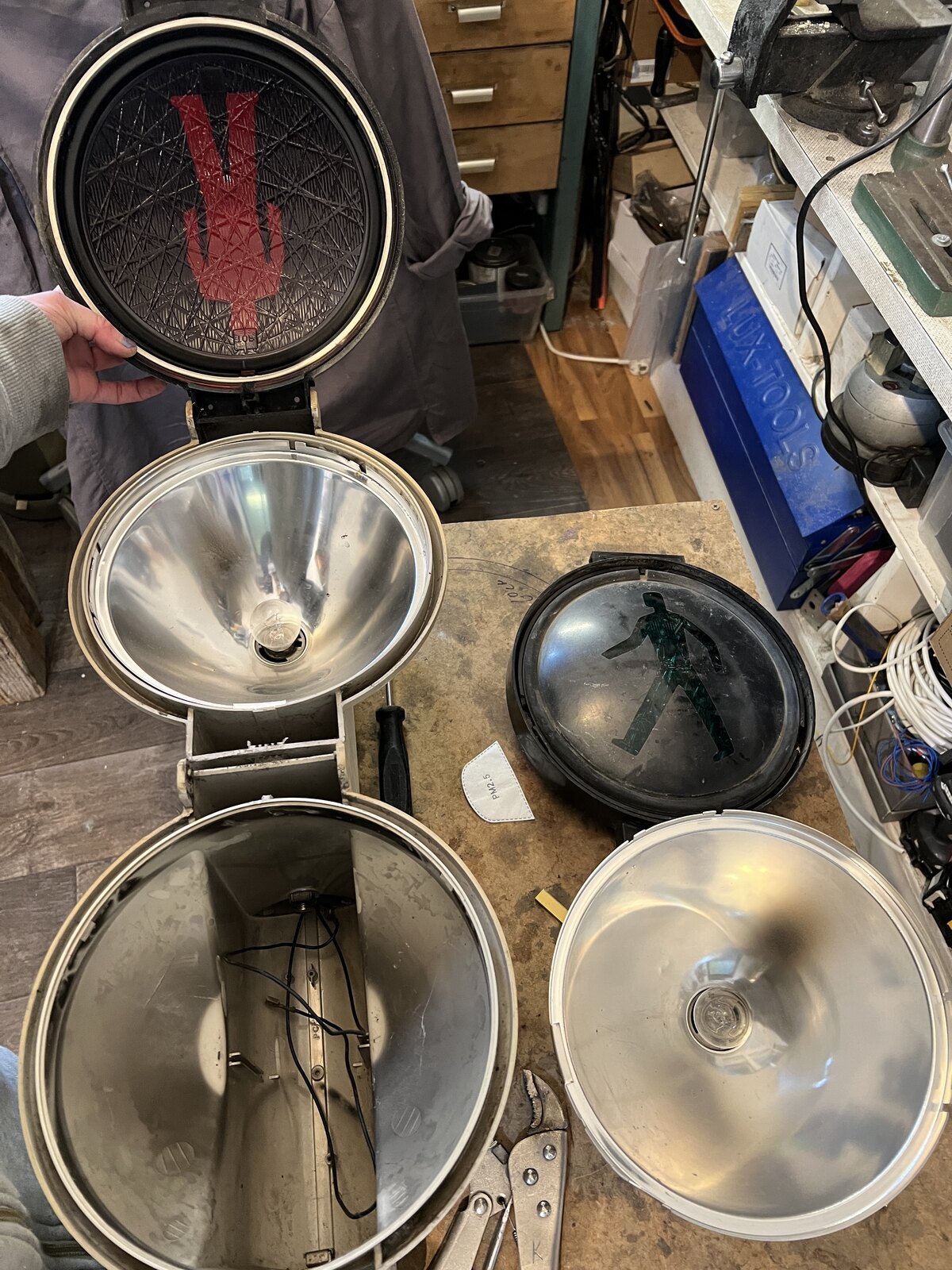Reflectors, lenses and the two housings laid out before the rebuild.