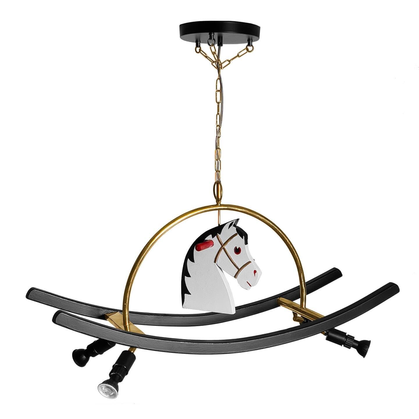 The finished Horse Lamp: the horse head inside a brass ring above two black rockers with downlights