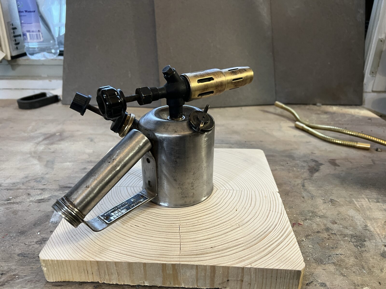 Blowtorch on its wooden base on the bench