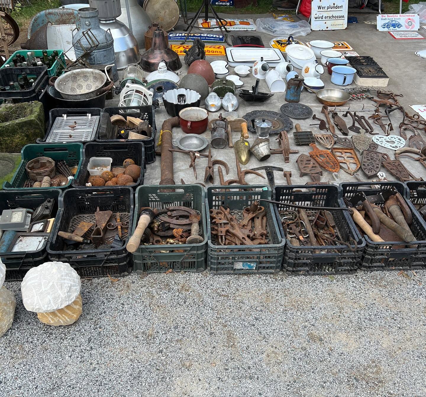 Market tables of old tools and metalware, in colour