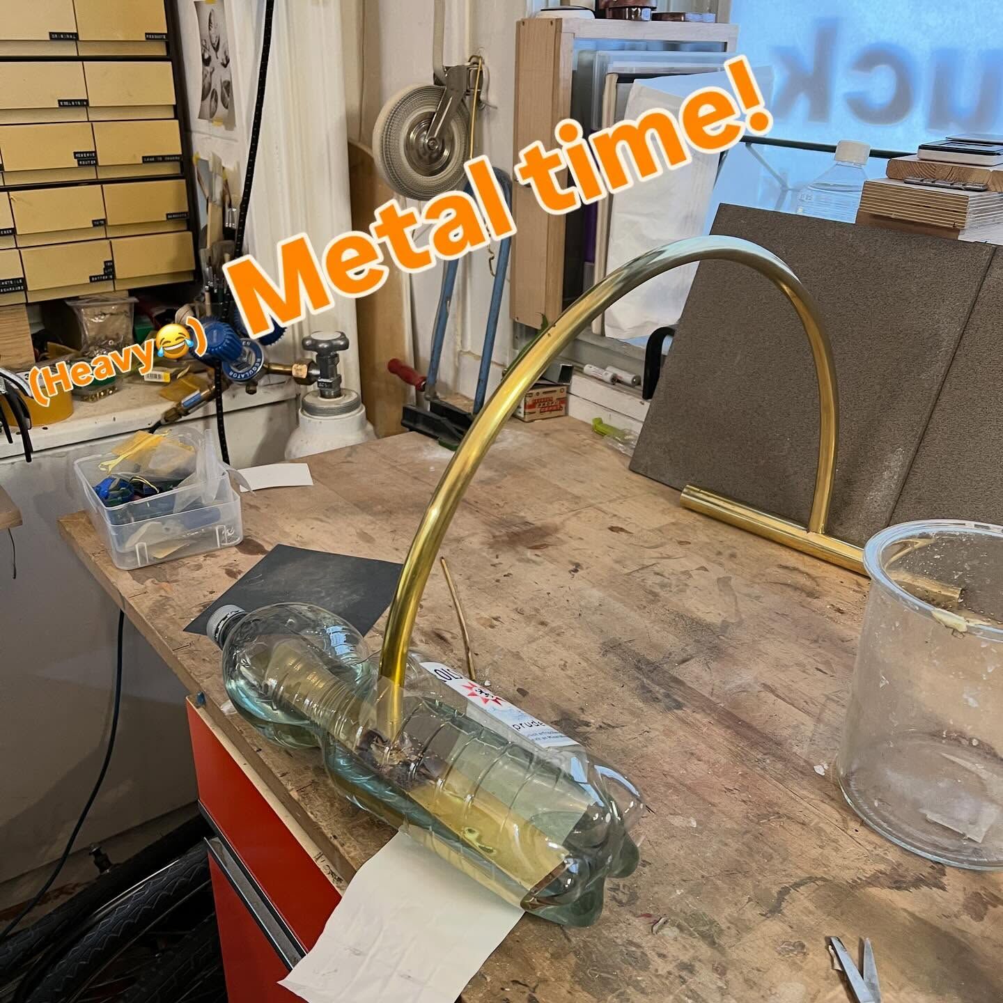 Story frame: bending brass tube at the bench, captioned Metal time