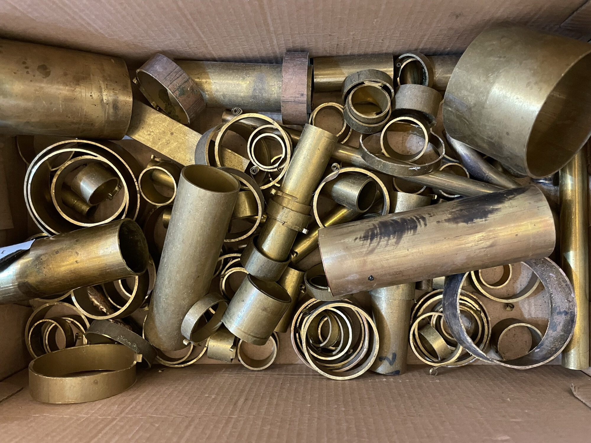 A box of brass tube offcuts and rings